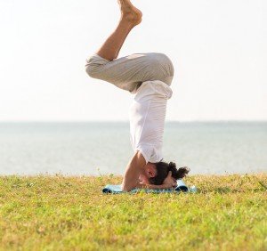 fitness, sport, people and lifestyle concept - man making yoga e